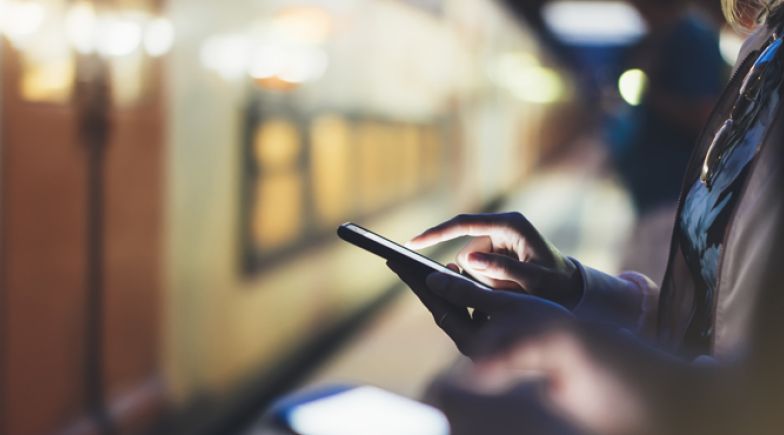 Woman using her smartphone at a station